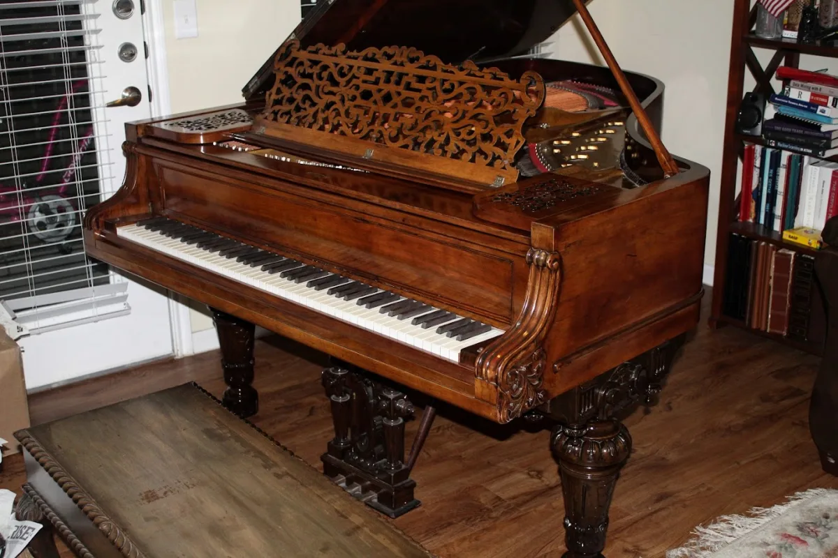 Grand piano open during a tuning session